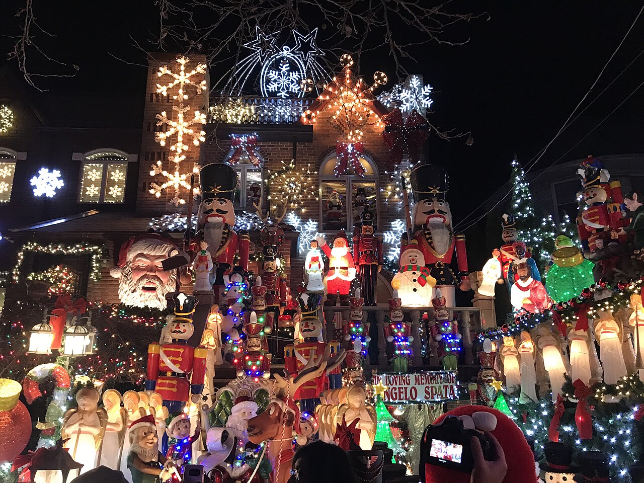 A Dyker Heights house covered in lights, inflatable Santas and nutcrackers